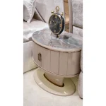 Rounded beige bedroom nightstand with decorative top and gold-tone trim