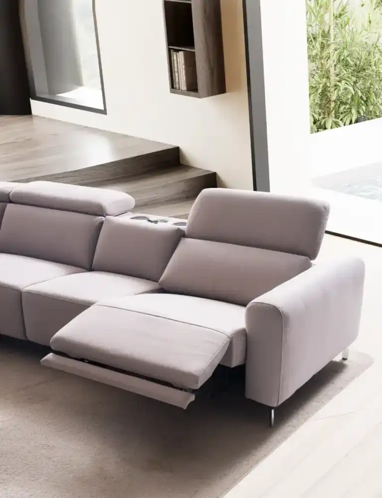 Close-up of a light gray power reclining modular sofa with adjustable headrest and footrest