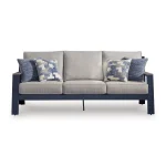 Front view of Sile navy blue outdoor sofa with driftwood-look arms, light gray cushions, and blue geometric throw pillows on white background