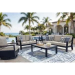 Complete Sile outdoor furniture collection arranged on poolside patio with sofa, loveseat, swivel chair, coffee table and blue patterned outdoor rug