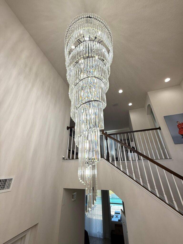 Luxury Staircase Chandelier – 8 ft high ceiling chandelier with K9 crystals in a modern home.