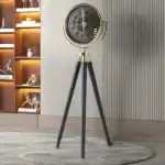 Elegant gold and black tripod floor clock with Roman numerals, perfect for modern home decor.