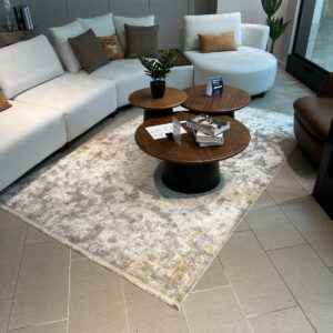 Turkish rug with intricate patterns in shades of grey and gold on display at De’Luxe Home Decor & Furniture in Tampa.