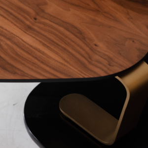 Close-up of the Bentley Swivel Coffee Table showcasing the walnut top and brush gold leg detail.