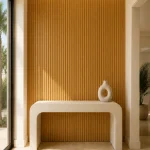 Oak fluted wall panel installed behind a console table in a modern entryway