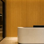 Oak slat wall panel installed behind a modern reception desk